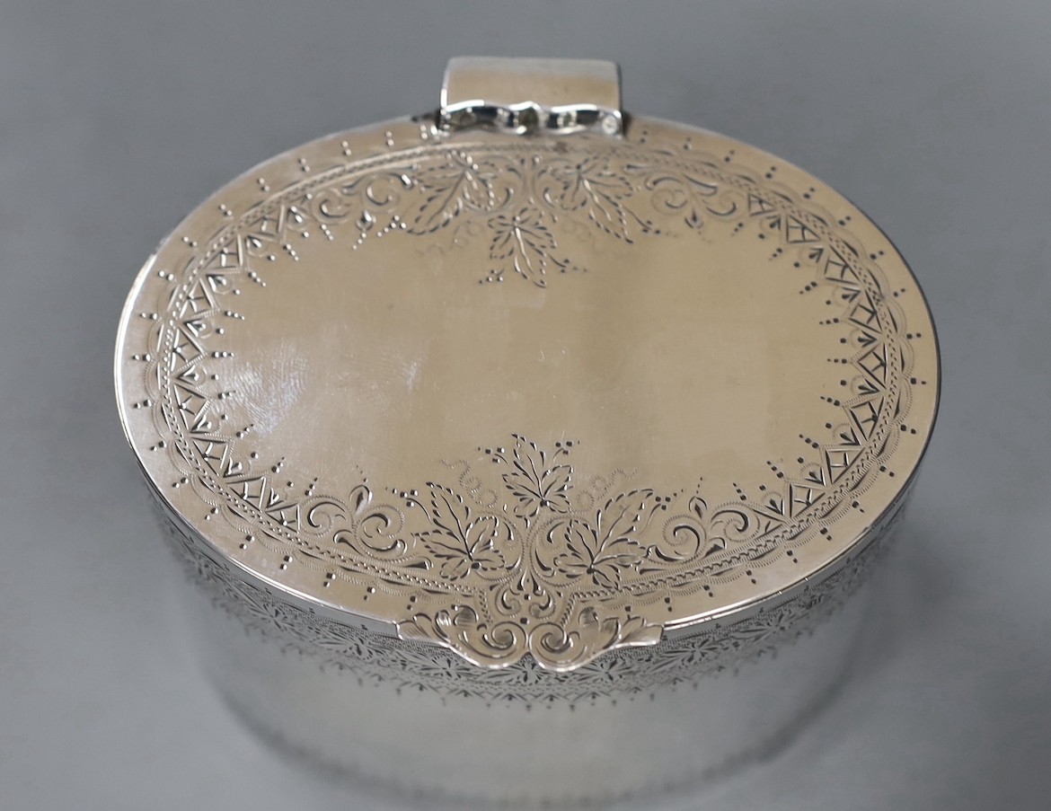 A late Victorian engraved silver oval tea caddy, Edward Hutton, London, 1891, height 74mm, 6.6oz.
